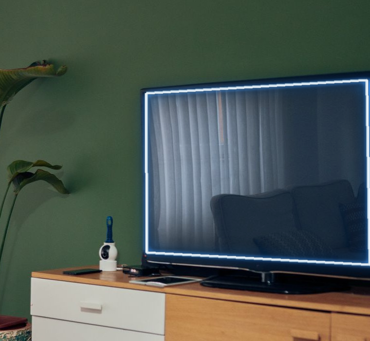 The room's television wrapped in the same crisp blue neon edge.